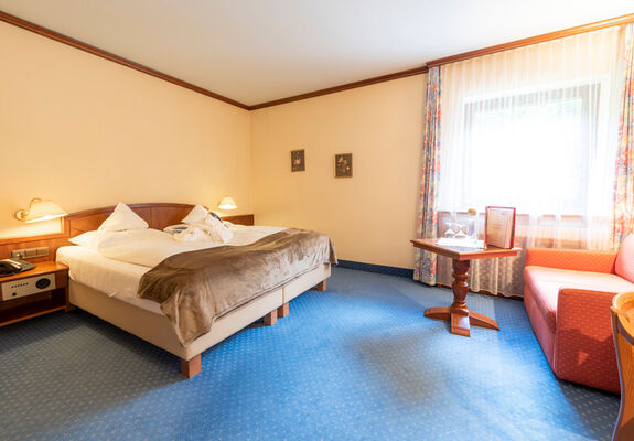 A double bed in a hotel room at Rindererhof